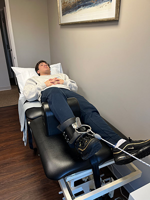 Chiropractic Marlton NJ Man On Knee Decompression Machine